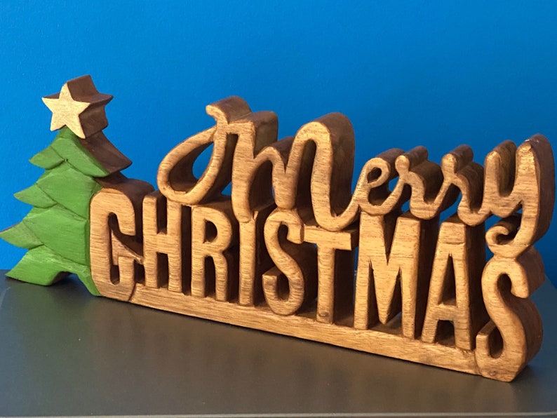 V277-WCMCD38-190225-00 Wooden carved Merry Christmas decoration 38 cm long with Tree and Star - Image 1